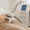 Woman receiving a CoolSculpting treatment on her abdomen using a modern machine in a clinic.